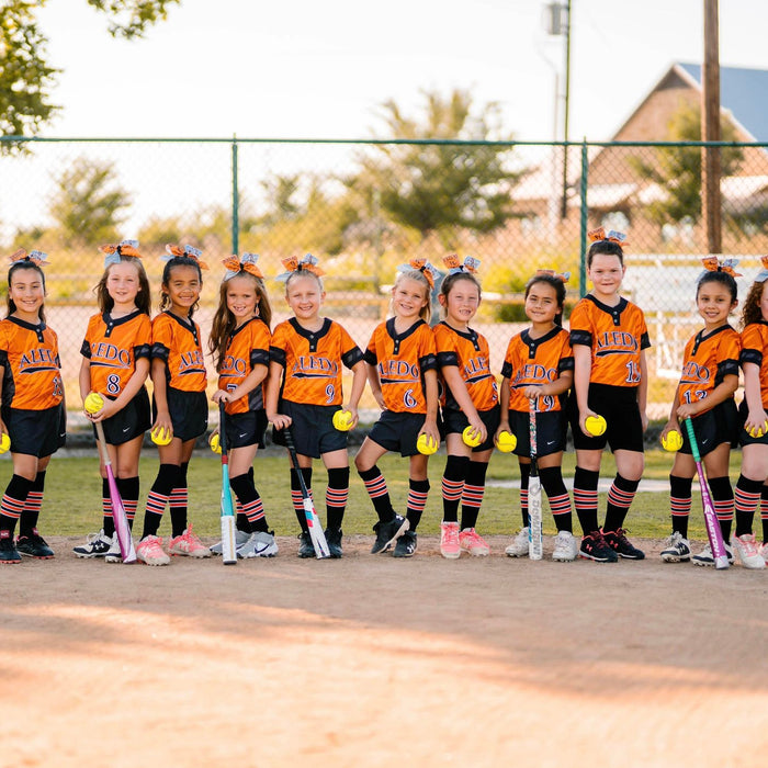 Youth girls softball socks, wearing black and orange pattern B dugout series socks