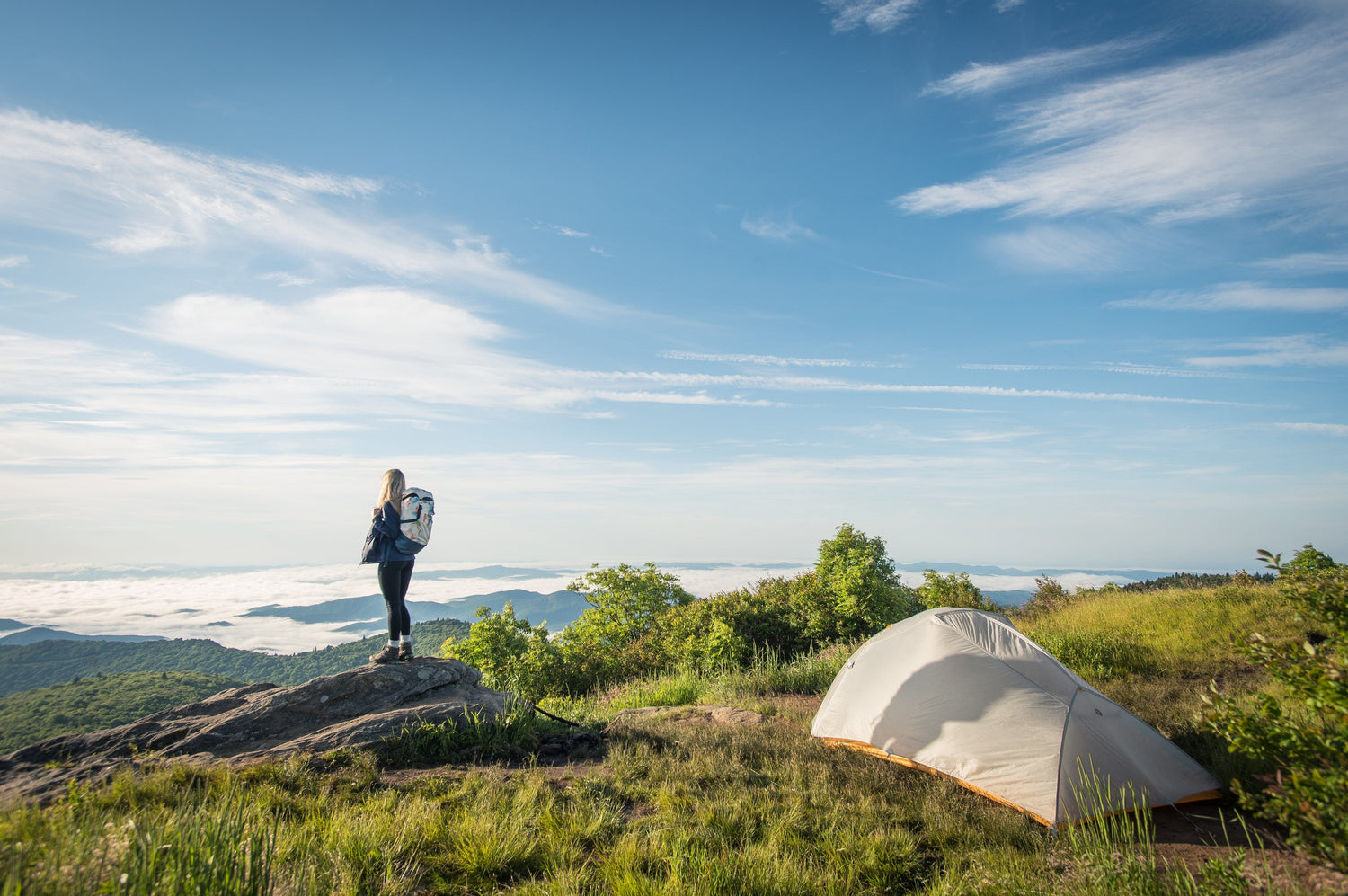 woman standing next to a tent