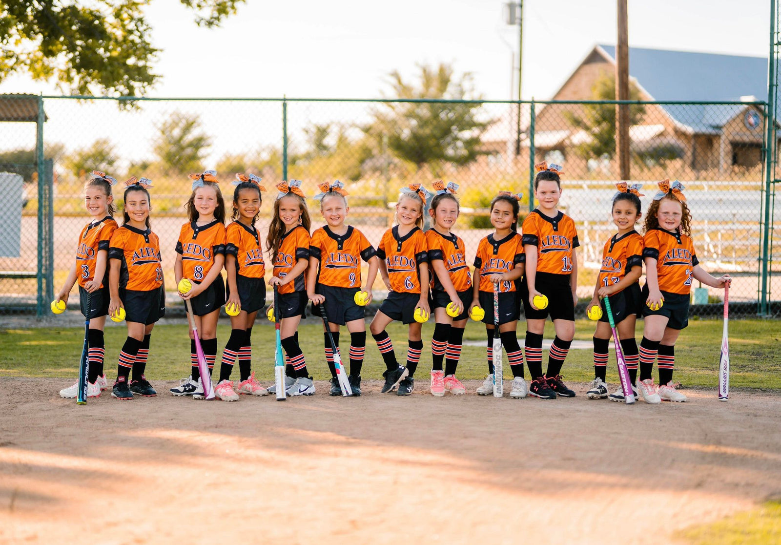 Youth girls softball socks, wearing black and orange pattern B dugout series socks
